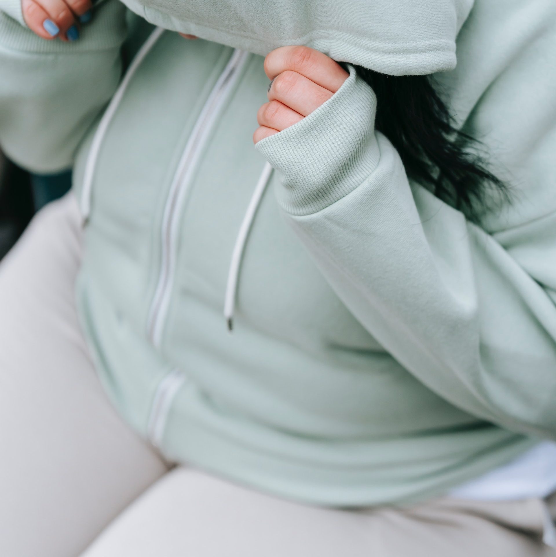 Woman in a hoodie who doesn't fit the social norms of weight. 